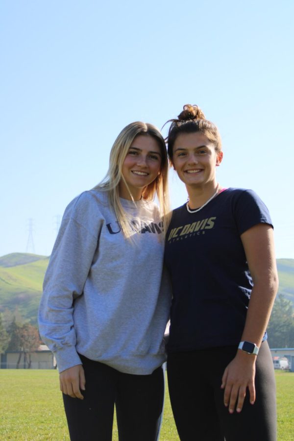 Lacrosse teammates Paige Davis and Annie Cimperman pose in their UC Davis shirts.