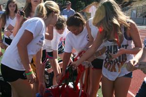 Powder puff players reach into a bucket of flags.
