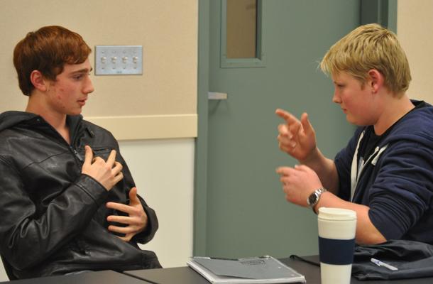 Sophomore Patrick White and junior Samuel MacAdam engage in a signing conversation 
