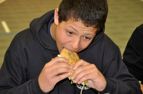 Sophomore Trevor Martinho eats a taco during Wrestlings end-of-season taco-eating contest.