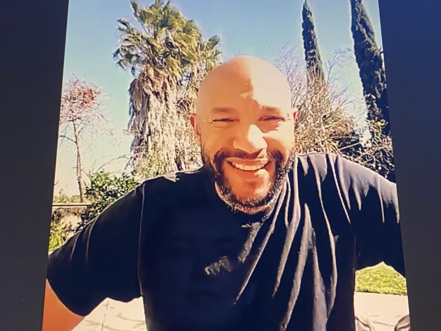 Stephen Bishop smiles in his backyard while Zooming with the Campo community.