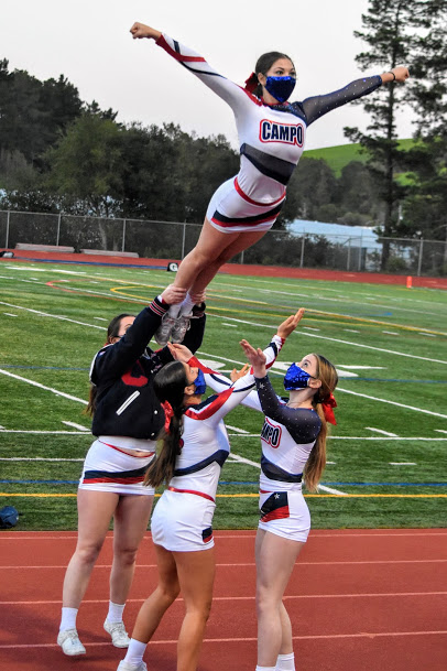 Competition cheerleaders perform a stunt at the Amador High School football game on April 3.