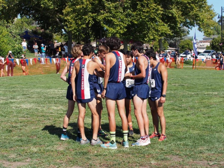 The Varsity boys stack hands to uplift each other before the race.