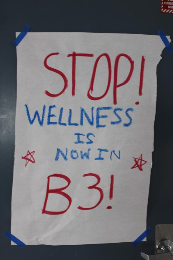 A poster redirects students to the new Wellness Center.