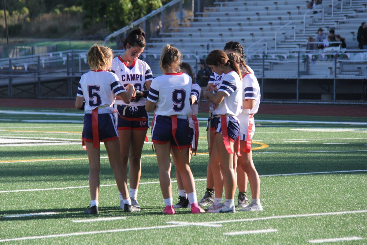 The Girls Flag Football team huddles up before the play.