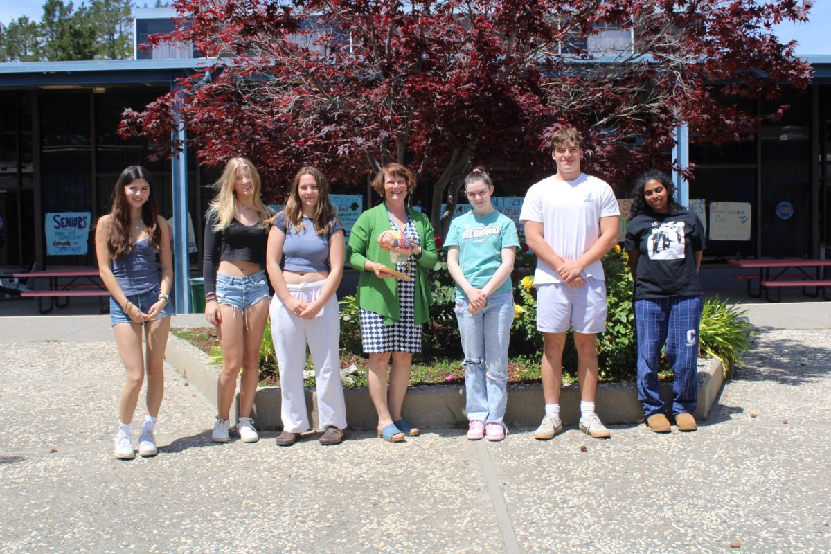Ms. Bessette poses with AP Psychology students and her brain model.