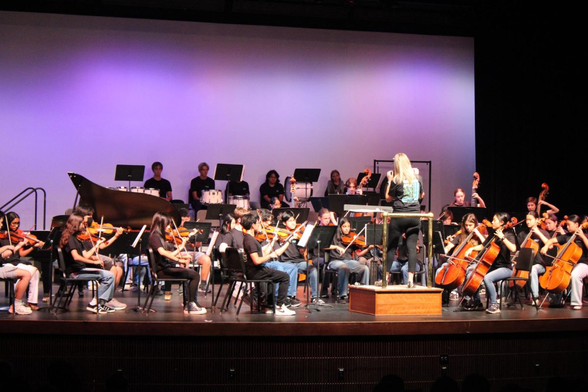 Band teacher Tana Barnett conducts the Campolindo string orchestra with rigor.