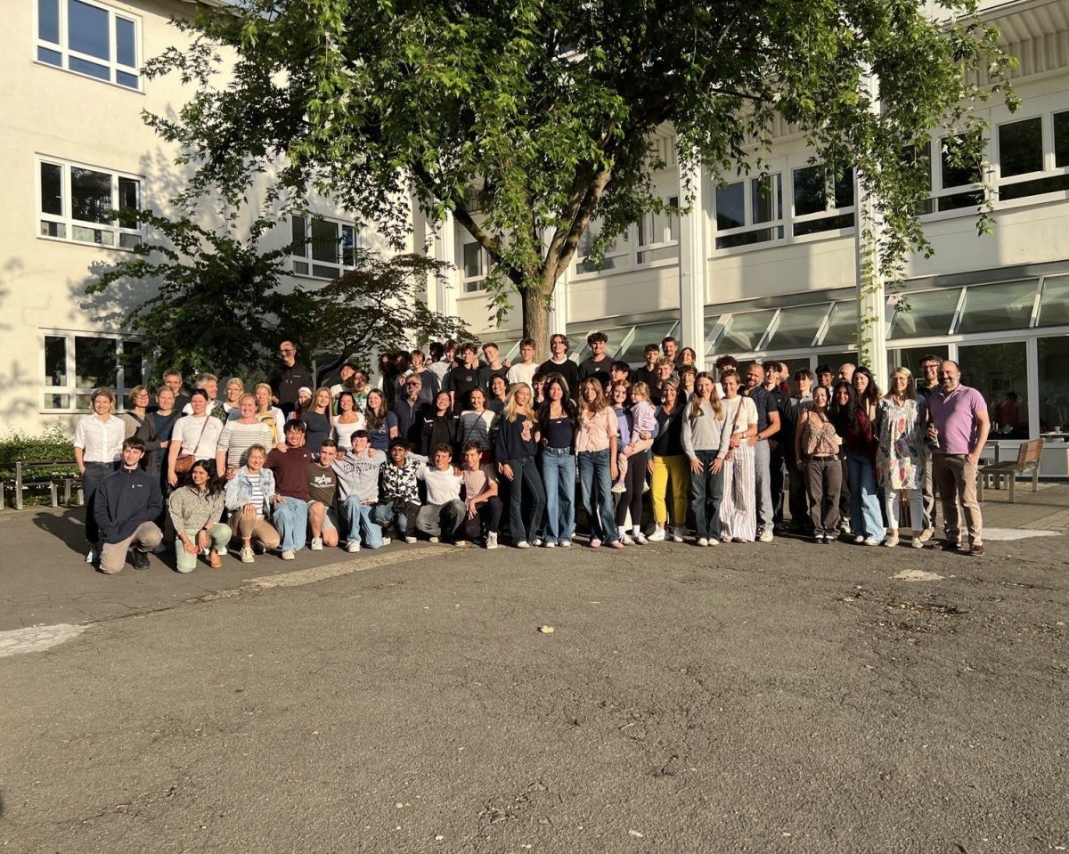 Students and their host families stand with one another after two weeks in Heidelberg. 