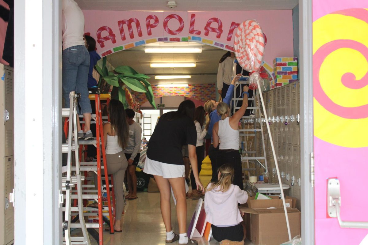 Students help out during Homecoming hallway decorating. 