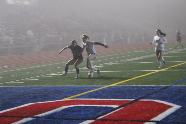 Junior Zoe Lehrman fights for the ball.  