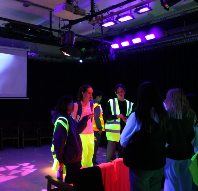 Video production students guide visitors around during open house night.