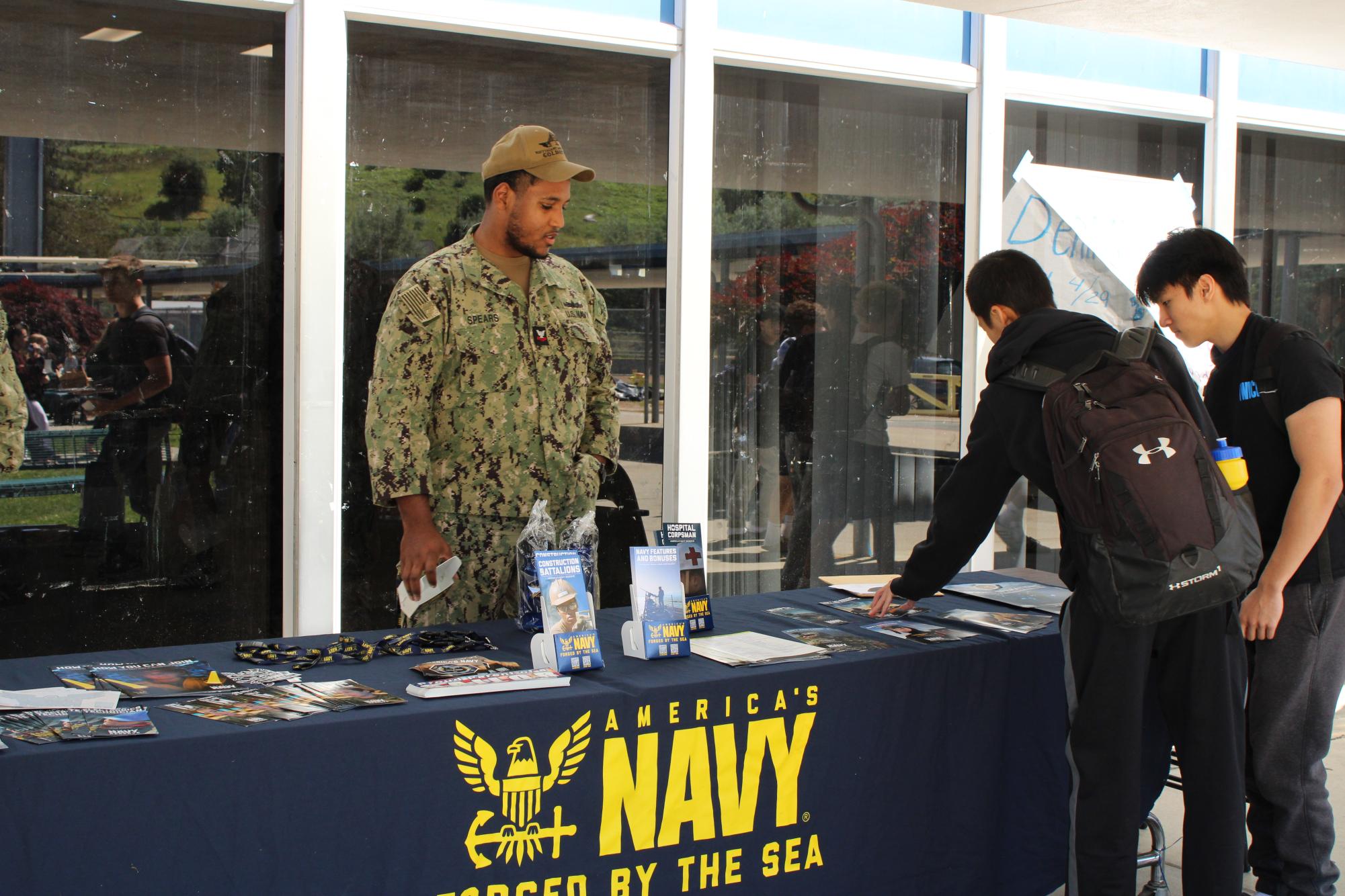 Navy reps set up booth at Campolindo. 